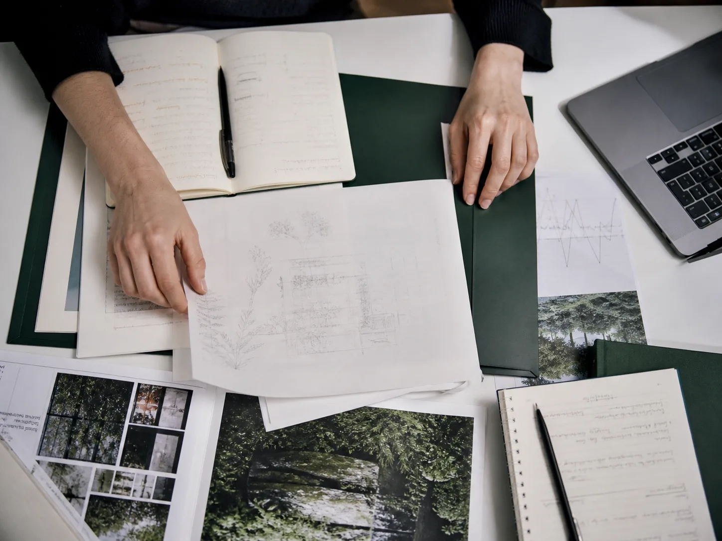 Documents, notebook and laptop arranged for recording placement evidence