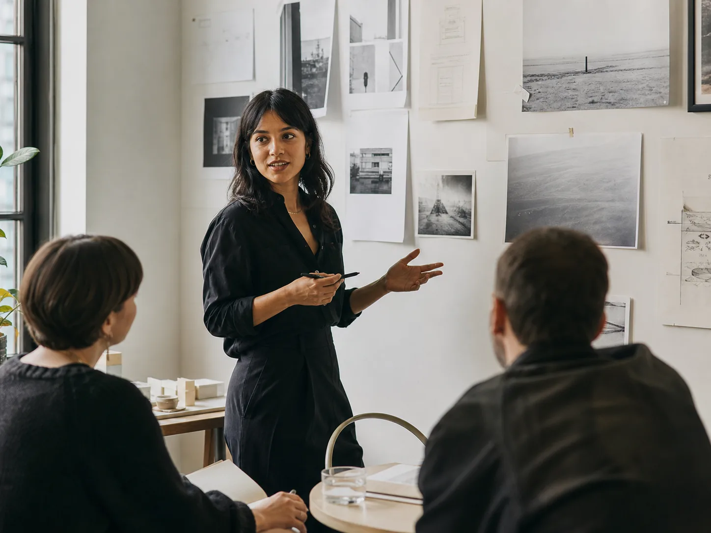 A young professional presenting their work to colleagues
